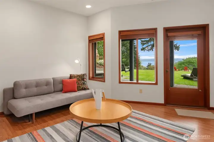 Inviting lower-level sitting room offers a peaceful lounge, reading retreat, or additional flex space.