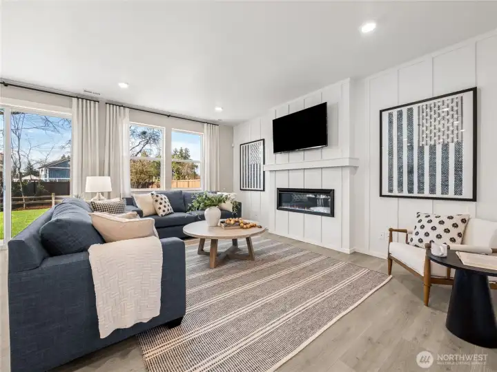 The family room boasts plenty of windows and light and features an electric fireplace, mantel above, and in wall wiring for your TV. Picture for representational purposes only, colors and features may vary. The family room boasts plenty of windows and light and features an electric fireplace, mantel above, and in wall wiring for your TV. Picture for representational purposes only, colors and features may vary.
