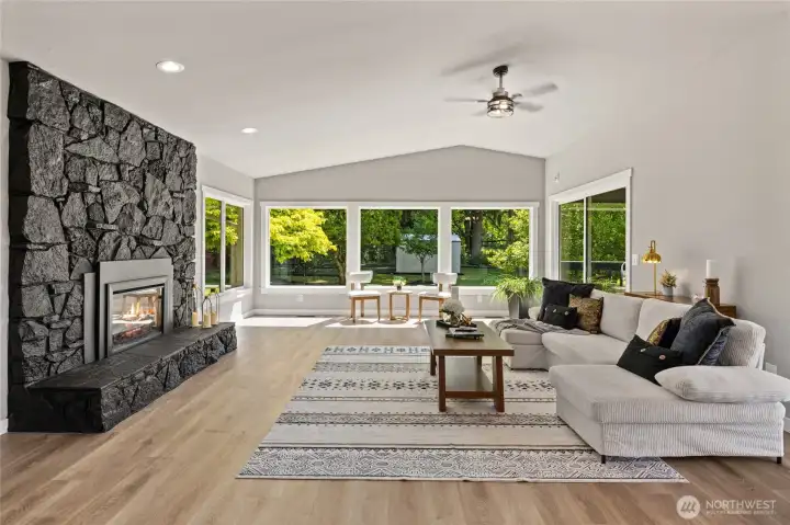 Vaulted light and bright Great room with new electric fireplace too!  2 oversized sliders off great room and dining room lead to covered deck!