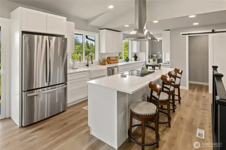 Spacious light and bright chef's delight kitchen!  New cabinets, farm sink, quartz countertops and back splash, huge eating island, new stainless steel appliances, great views, coffee bar area and HUGE walk in pantry with barn door.  Sellers to give new buyers $3000 allowance towards new pantry system and have various designs to choose from!