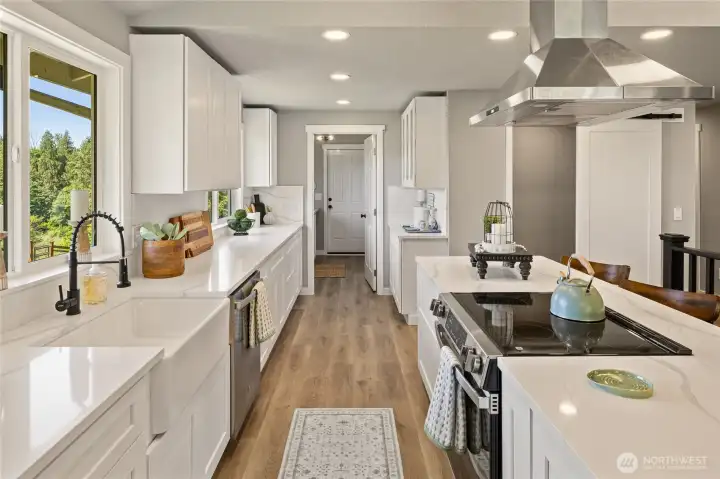 Crisp, clean, Quartz Counter space galore, prep areas, cooking areas and great for entertaining guests!