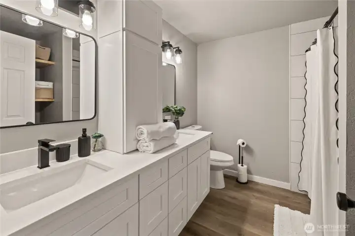 Full Bathroom with dual sinks, new cabinets, flooring, tile, shower/tub and more!  Huge storage area behind door perfect for Everything!