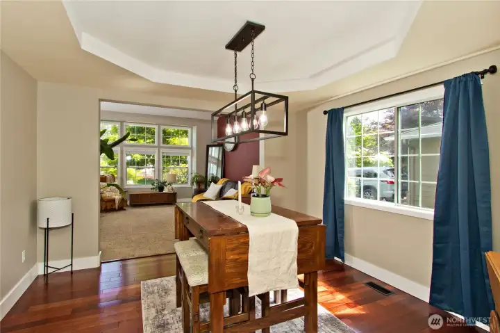 Beautiful rich-toned hardwood floors elevate the dining room with a touch of sophistication and timeless charm Beautiful rich-toned hardwood floors elevate the dining room with a touch of sophistication and timeless charm