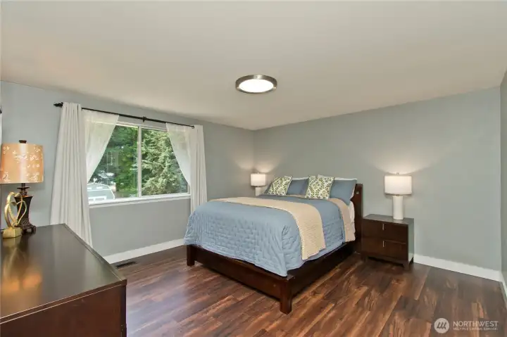 The spacious primary bedroom features a beautiful picture window that fills the room with natural light and offers peaceful views to your beautiful backyard The spacious primary bedroom features a beautiful picture window that fills the room with natural light and offers peaceful views to your beautiful backyard