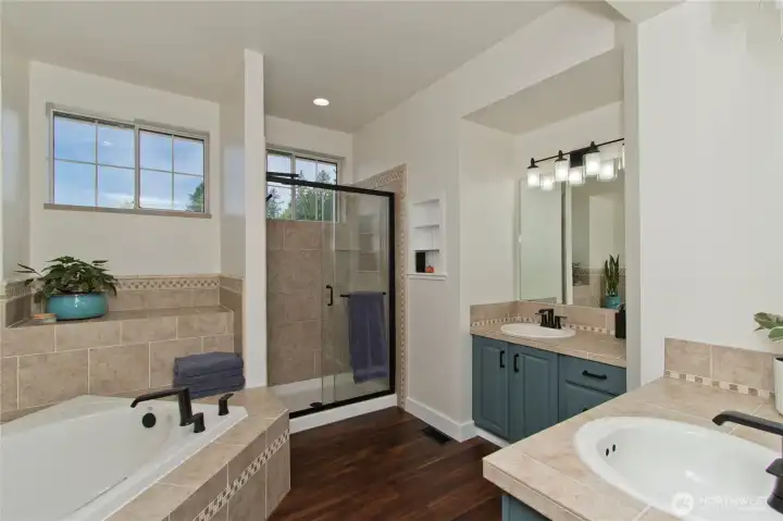 The primary ensuite offers a relaxing soaking tub, separate shower, and dual vanities for added comfort and convenience The primary ensuite offers a relaxing soaking tub, separate shower, and dual vanities for added comfort and convenience
