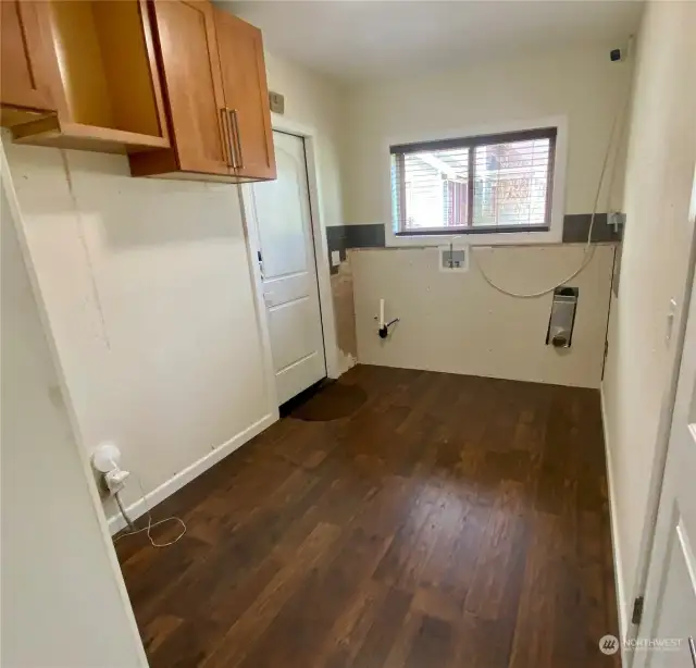 Large utility room right off the kitchen.  Door on left leads outside...door on right  leads to the garage!