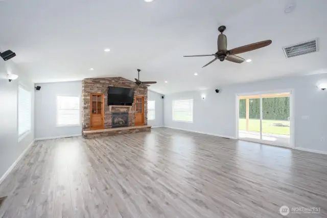 The beautiful Brickwork and Fireplace of the Living Room with a View out to the Patio.