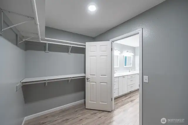 Spacious primary walk-in closet.