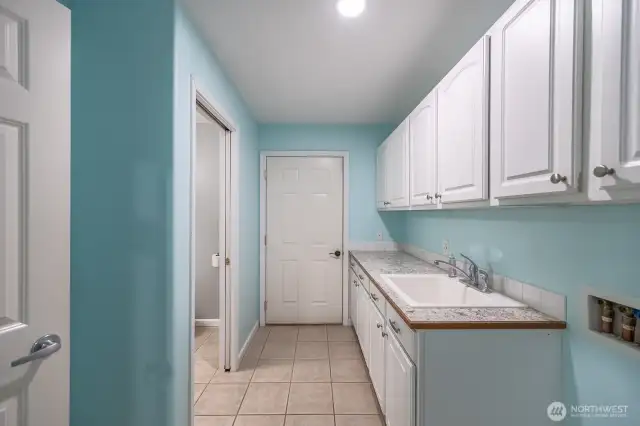 Laundry Room with a 1/2 bath and entry to the garage.