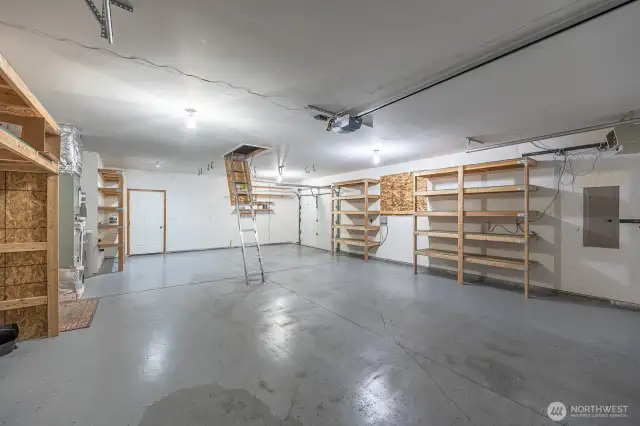 This large garage provides shelves for storage, access to the attic and backyard. Equipped with a 3rd garage door for the "Project!"