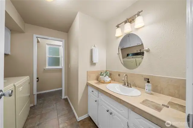 Third bathroom on lower level combined with laundry area