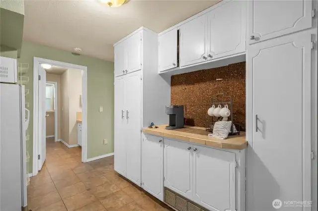 Lower level hallway with fridge, endless storage refreshment area