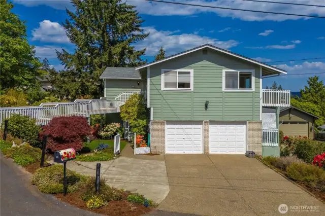 Gate to the left of the garage leads to private entrance to lower level office/studio or potential MIL/Airbnb.