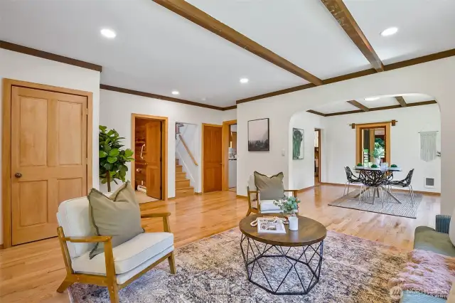 Living looking to formal dining area.  L to R doors/doorways:  coat closet, full bathroom, stairs up, door to basement.  Just beyond this, the kitchen is located in that back corner.