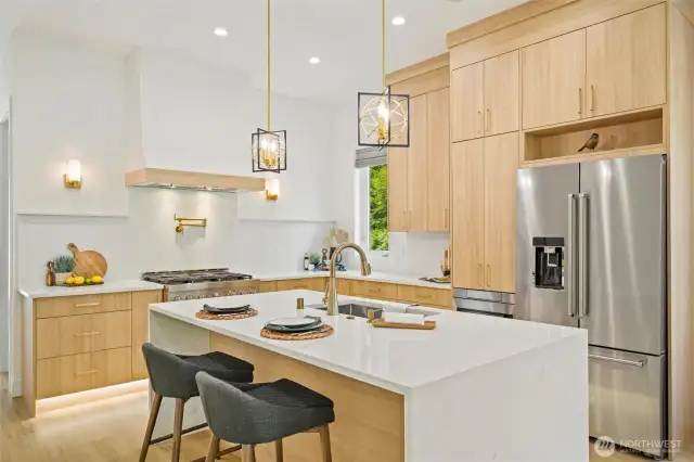 The kitchen is more than just a space—it’s the heartbeat of the home. Picture yourself preparing meals at the commercial-grade range, rinsing fresh herbs beneath the pot filler, and sharing wine with friends at the island, laughter echoing into the open-concept living area.