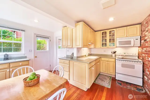 Light and bright kitchen with Corian counters and room to gather, cook, and share stories.