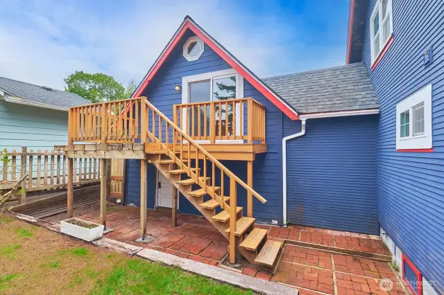Postage stamp-sized back yard and stairs leading to studio apartment.