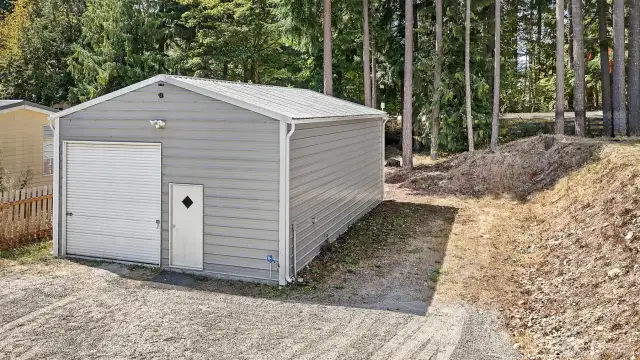 The shop has no attention to detail spared and includes RV hookups to the right, along with a water spigot.
