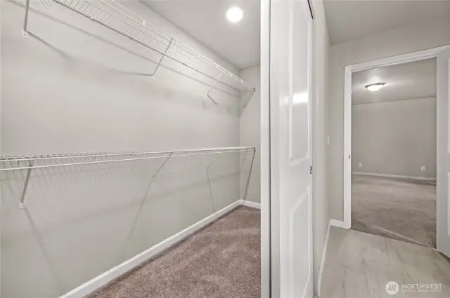 Walk-in closet of primary bedroom