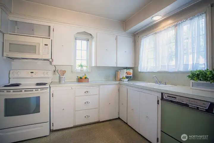 light and bright kitchen with original leaded glass windows and vintage KitchenAid dishwasher