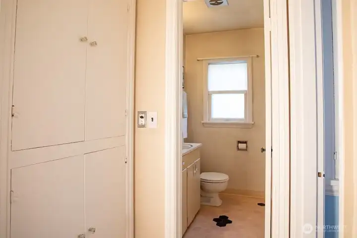 Hallway storage with bathroom beyond