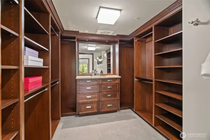 Walk-in closet with custom built-in cabinetry.