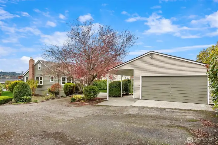 Generous double garage with covered RV parking, and extra parking spaces.