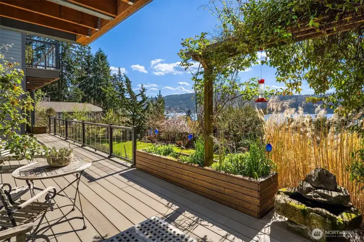 The lower level deck leads to beautiful, lush landscaping, a greenhouse, raised beds, garden shed and covered storage ~ certain to inspire any green thumb, lawn space great for pets & play that completes a serene and usable outdoor space.