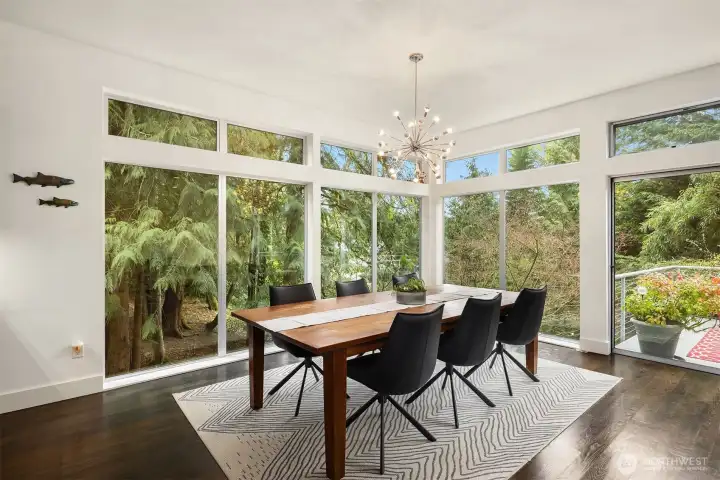 Dining area framed by windows and natural views.