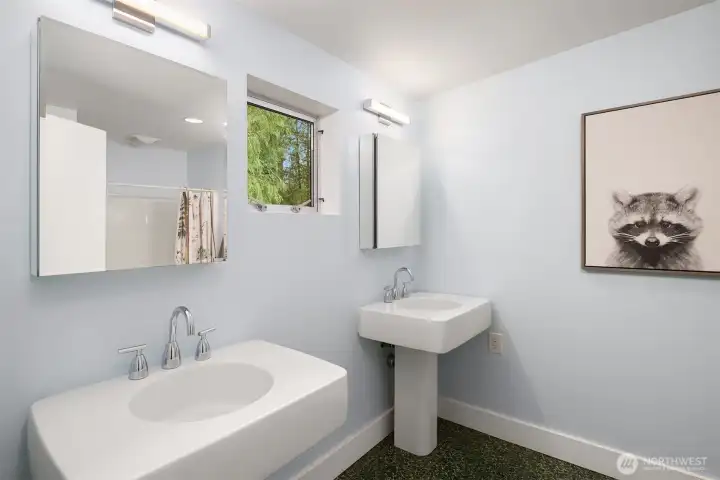 Main level half bath with a pedestal sink.