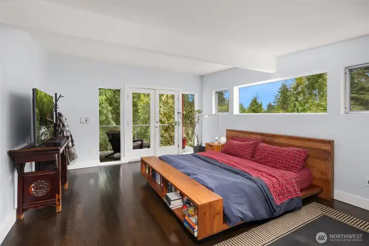 Spacious primary bedroom with tranquil views.