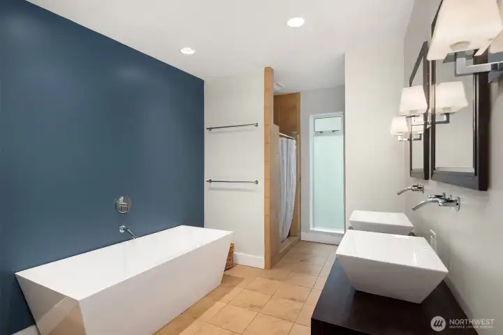 Primary bath has a spa-like feel with refined finishes.