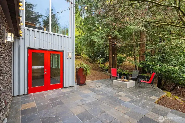 Outdoor fireplace creates a warm gathering spot.