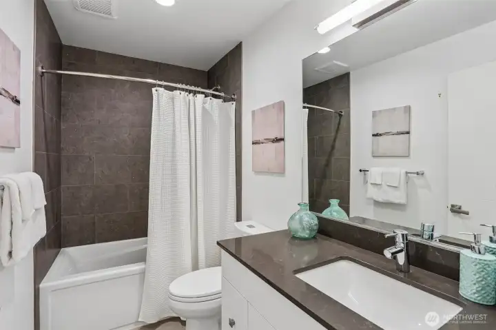 Full bath on the first level, just outside of bedrooms 2 and 3.