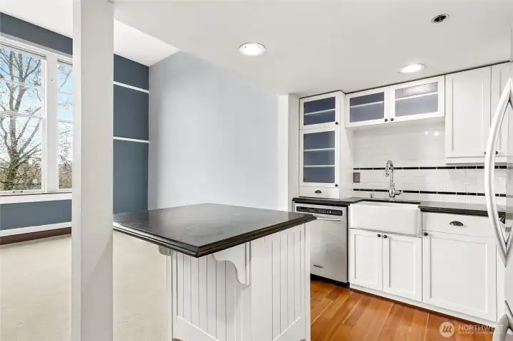 Perfectly connected to the living room, the kitchen also features a central island with eating space.