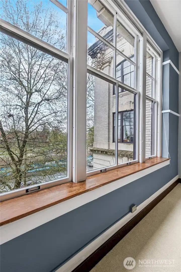 Generous windows welcome the outdoors in, filling the space with light and natural views.