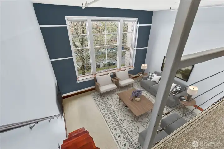 Architectural volume and natural light define this beautiful vaulted living room below the loft. This photo has been virtually staged.
