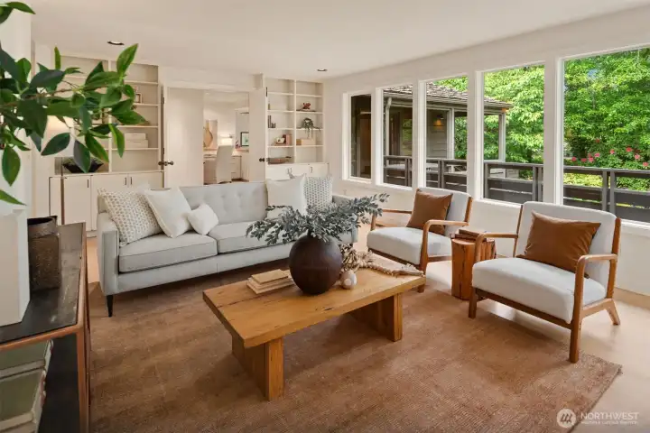 Formal living room with garden views and a custom copper surround on the wood-burning fireplace. Formal living room with garden views and a custom copper surround on the wood-burning fireplace.