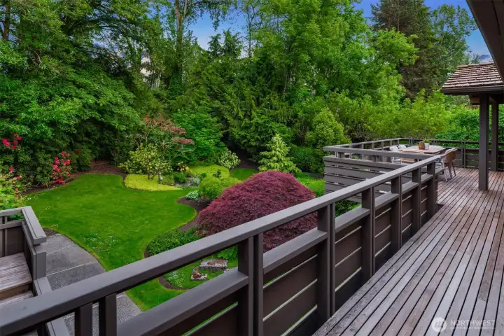 Enjoy backyard views from the spacious wraparound deck, which spans the entire back of the house from the kitchen to the primary suite. Enjoy backyard views from the spacious wraparound deck, which spans the entire back of the house from the kitchen to the primary suite.