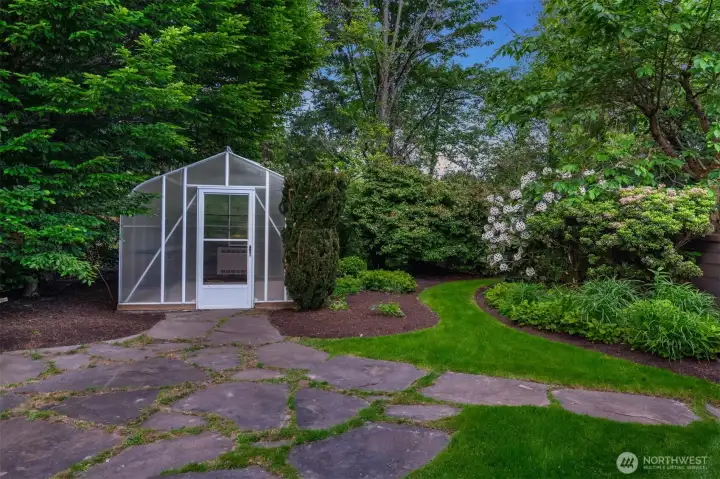 On the north side of the property, stone walkways lead to the greenhouse and large raised bed area, an ideal place to exercise your green thumb On the north side of the property, stone walkways lead to the greenhouse and large raised bed area, an ideal place to exercise your green thumb
