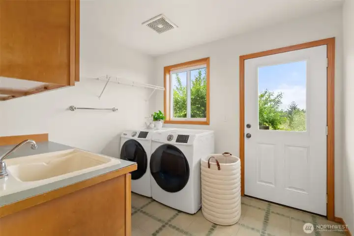 Utility room on main with door to backyard.