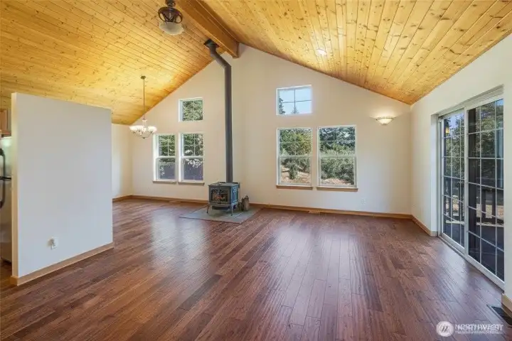 Cozy Lopi wood stove anchors great room w/soaring knotty pine ceilings and solid oak flooring... Cozy Lopi wood stove anchors great room w/soaring knotty pine ceilings and solid oak flooring...