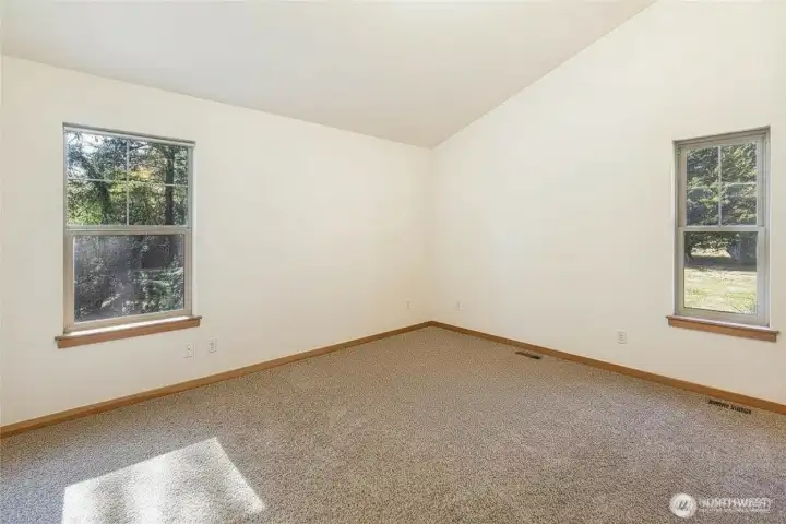 Primary bedroom with vaulted ceilings and ensuite bath... Primary bedroom with vaulted ceilings and ensuite bath...