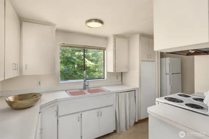 Designed for everyday functionality, the kitchen offers a well-organized workspace with generous storage.