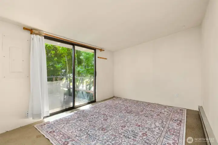 A sliding glass door in the bedroom provides direct access to the deck and invites in natural light.