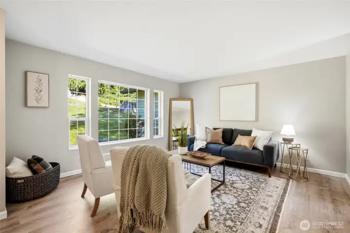 Sunlight pours through the windows, filling this welcoming living room with natural warmth. Sunlight pours through the windows, filling this welcoming living room with natural warmth.
