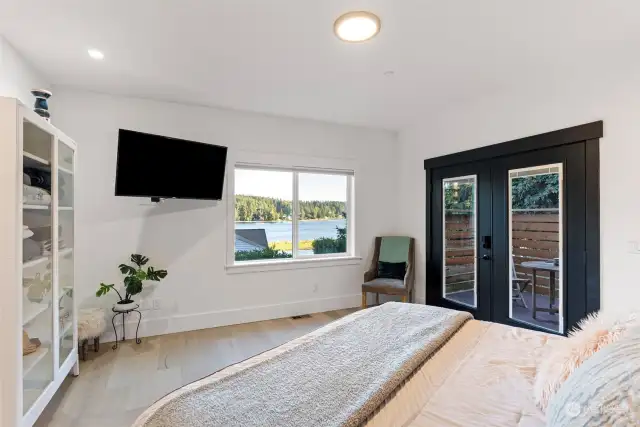 The primary bedroom is located on the main floor. Views from this room won't disappoint. The French doors lead to your private deck.