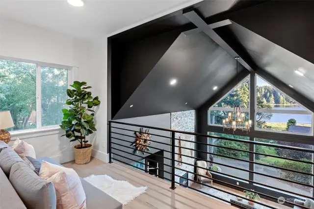 A loft on the 2nd floor captures the same amazing views. The metal see-through banister means you can take in what's going on below while still being a bit removed from it all.