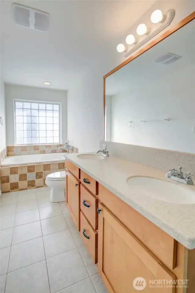 The large 5 piece primary bathroom is clean and bright.