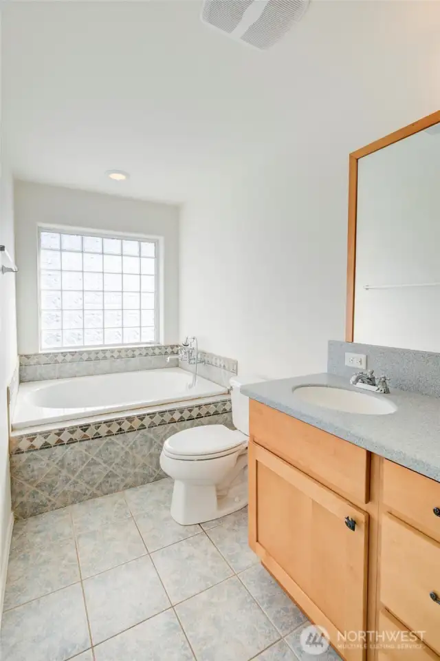 Sunny soaking tub and double vanities.